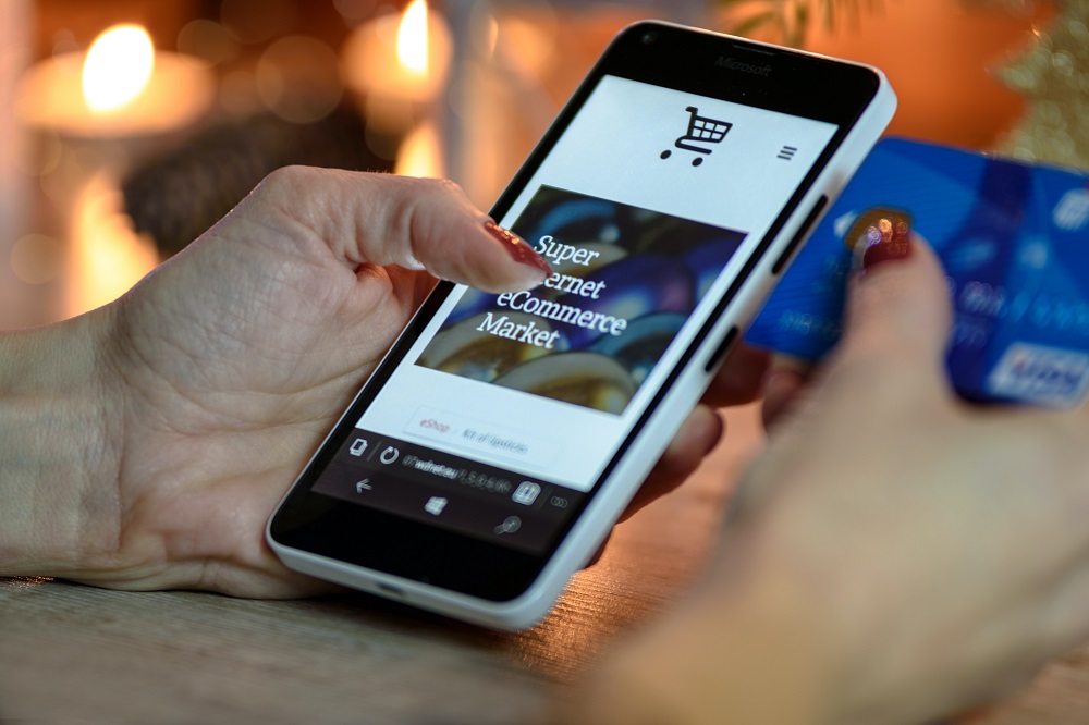 Hand using a smartphone - ecommerce in 2020