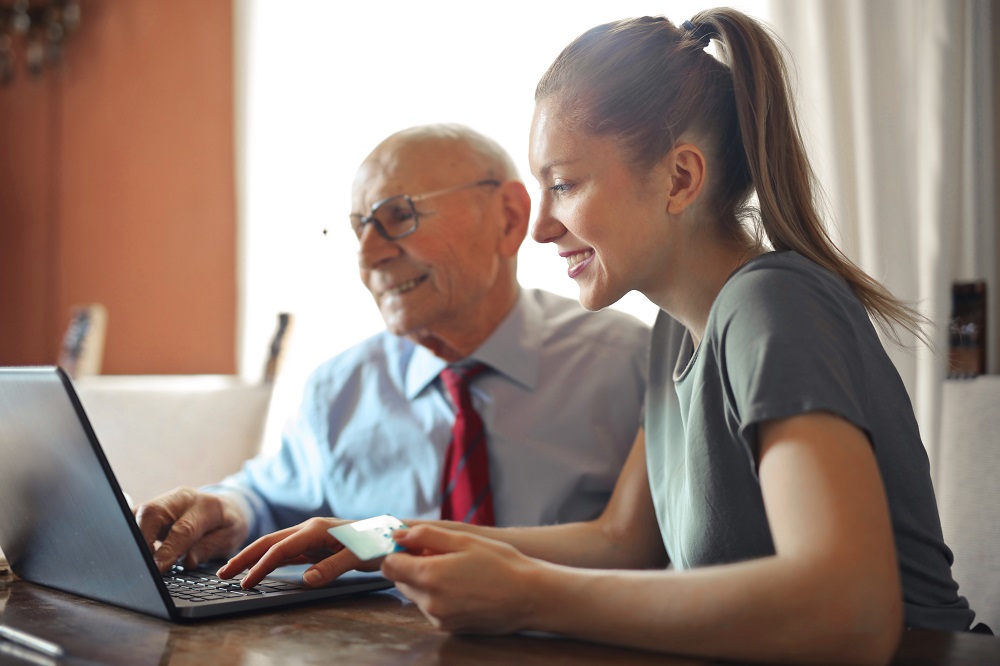 Older and younger person using a computer - ecommerce in 2020