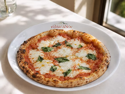 Margherita pizza on a branded restaurant plate — shot on site by a Splento creator