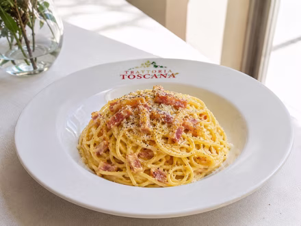 Spaghetti carbonara plated in the dining room — shot on site by a Splento creator