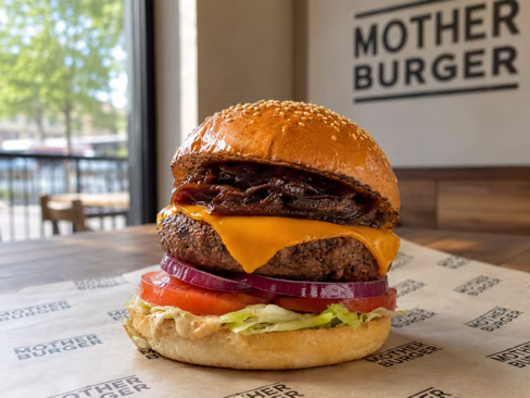Cheeseburger on branded paper in the restaurant — shot on site by a Splento creator